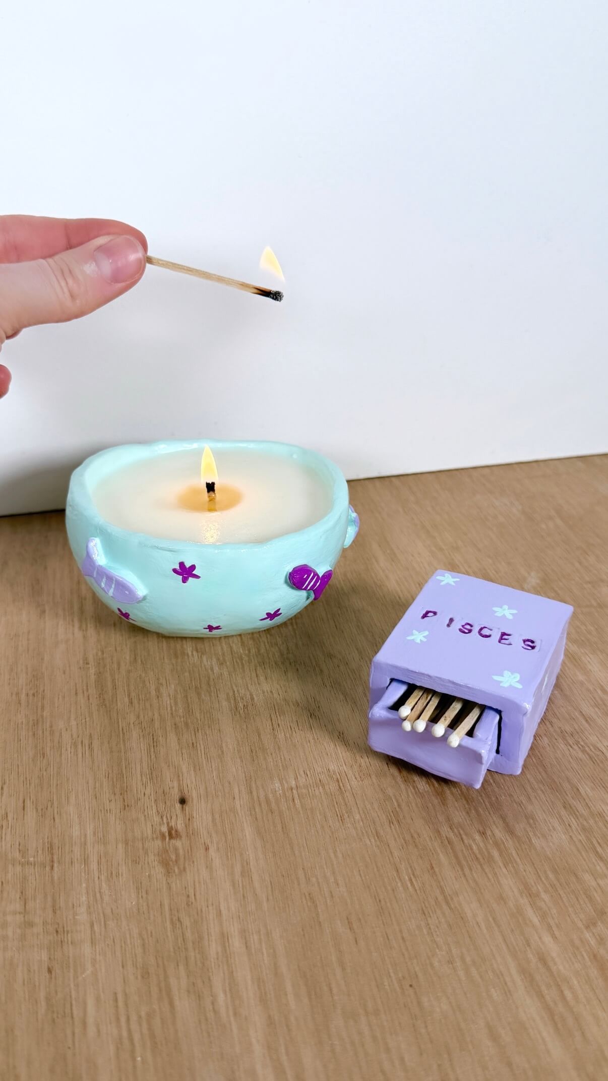 hand-poured soy candle with Pisces zodiac symbol