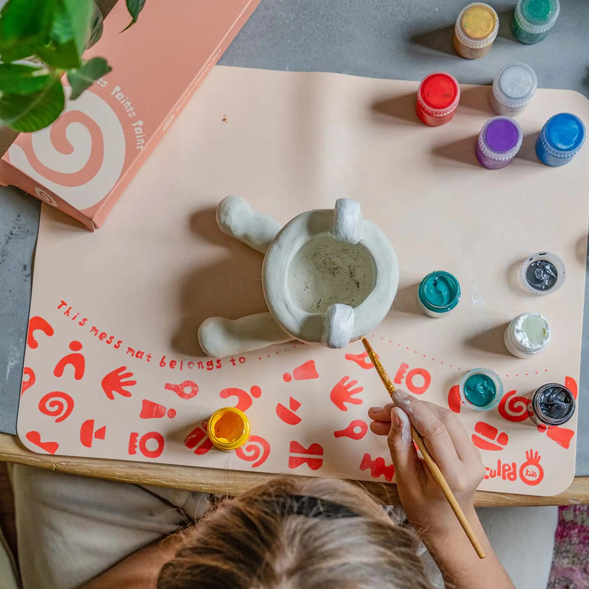 Painting pottery with Sculpd kids mess mat